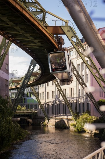 The Wuppertal suspension railway over the riverbed of the Wupper near the Kluse stop, Wuppertal, Germany, digitally reworked