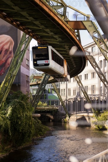 The Wuppertal suspension railway over the riverbed of the Wupper near the Kluse stop, Wuppertal, Germany, digitally reworked