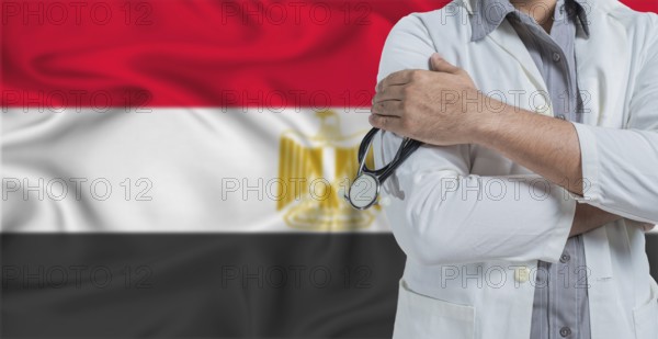 Doctor with stethoscope on arm with Egypt flag behind. National health system of Egypt, concept