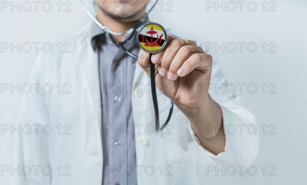 Brunei national healthcare. Doctor showing stethoscope with Brunei flag