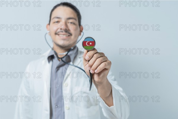 Smiling doctor showing stethoscope with Azerbaijan flag. Azerbaijan national healthcare