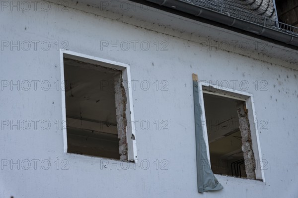 Building wall with empty window openings during house renovation or construction project