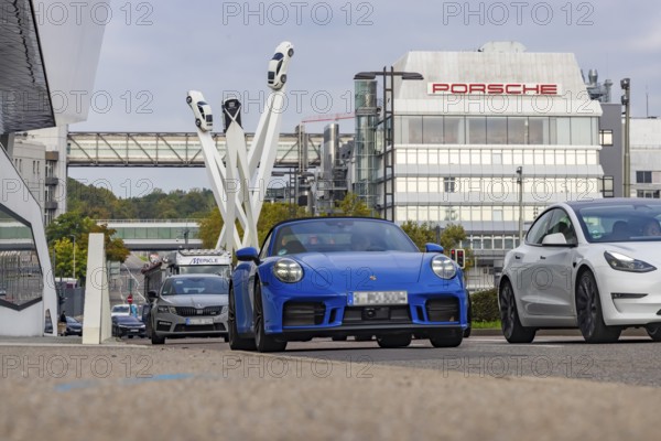 Porscheplatz with Porsche headquarters. Inspiration 911 artwork by Gerry Judah: three steles, each presenting a Porsche 911 at a height of up to 24 metres. Zuffenhausen, Stuttgart, Baden-Württemberg, Germany