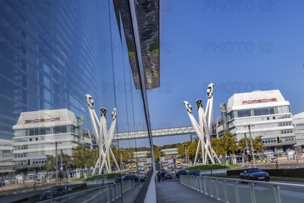Porscheplatz with Porsche headquarters. Inspiration 911 artwork by Gerry Judah: three steles, each presenting a Porsche 911 at a height of up to 24 metres. Zuffenhausen, Stuttgart, Baden-Württemberg, Germany