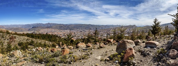 View of a city embedded in a mountainous landscape under a clear blue sky, view over the city of Potosi in Bolivia