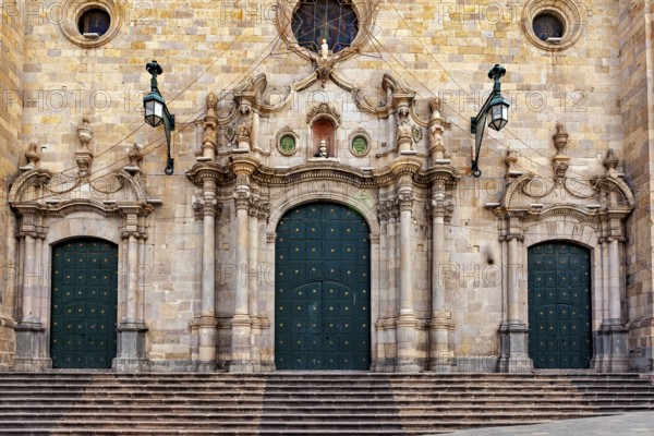 Monumental façade with three green double doors and complex decorations, impressive symmetry, The churches in Potosi in Bolivia