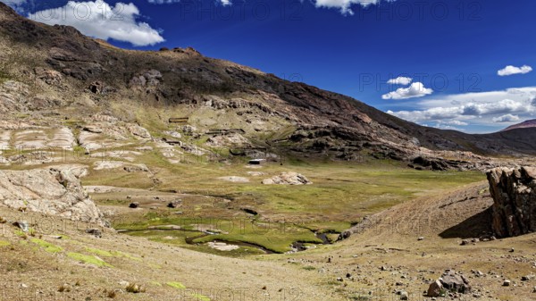 Vast, mountainous landscape under a clear blue sky with white clouds, The landscape near Potosi in Bolivia