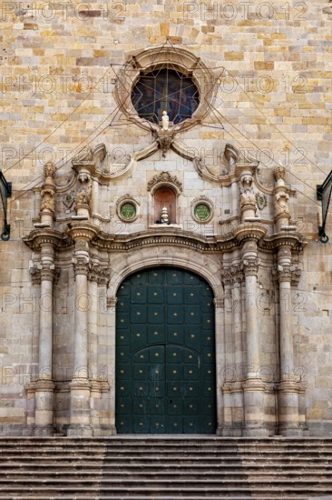 Historic stone façade with large green door and decorative columns, imposing and elegant architecture, The churches in Potosi in Bolivia