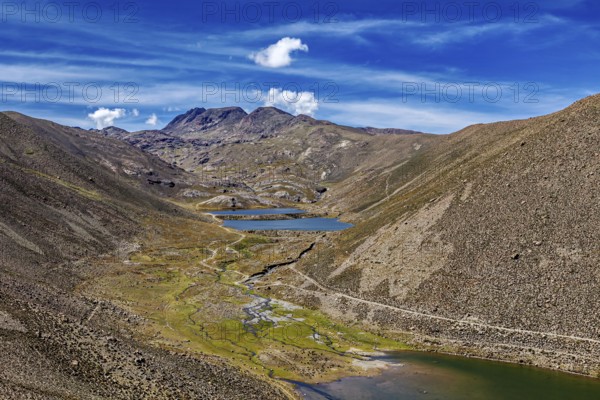 Valleys and rivers wind through mountainous terrain under a blue sky, The landscape near Potosi in Bolivia