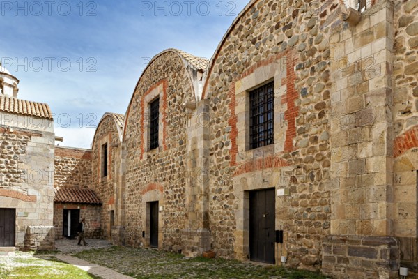 Historic stone buildings with tile accents and curved roofs under a blue sky, The historical museum of Potosi in Bolivia