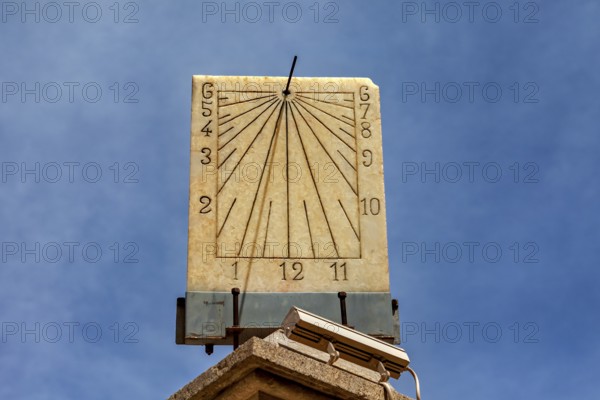 Classic stone sundial with clear dial and hands against a sunny background, The sundial of Potosi in Bolivia