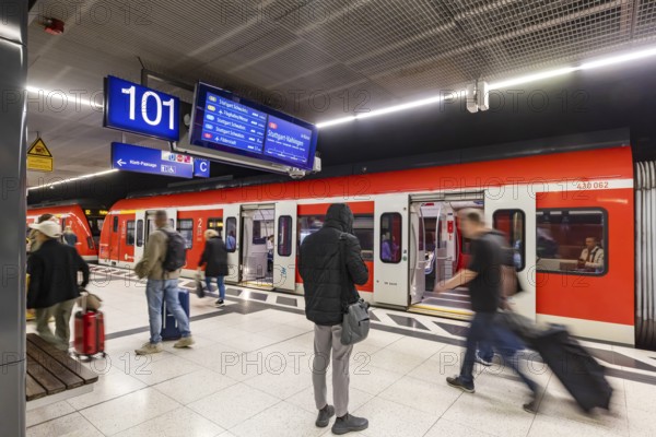 S-Bahn arriving underground at the main station stop. Platform with travellers. Stuttgart, Baden-Württemberg, Germany