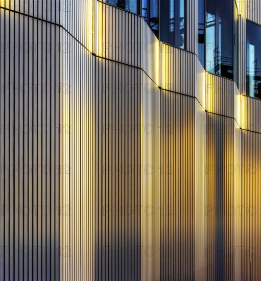 The picture shows a modern office and commercial building at the central station, warm evening light, Berlin, Germany