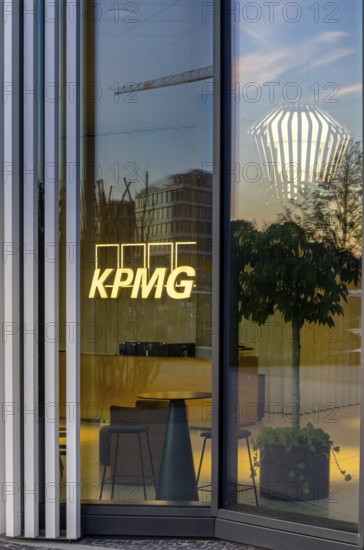 The picture shows the interior of a modern Berlin restaurant, taken in the evening, the scene is characterised by modern lighting fixtures reminiscent of large, glowing light bulbs, Berlin, Germany