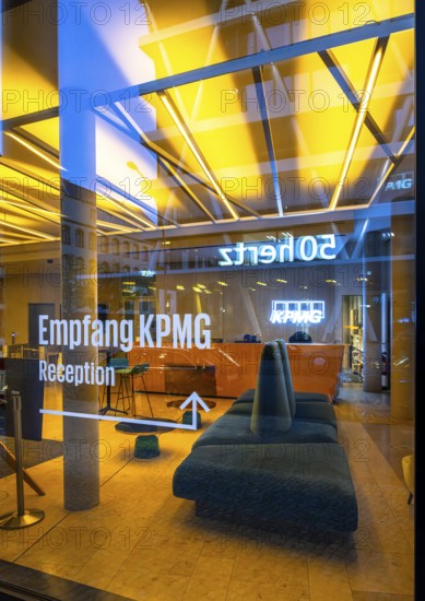 The picture shows the interior view of the modern foyer of KPMG Haus am Hauptbanhof, taken in the evening, Berlin, Germany