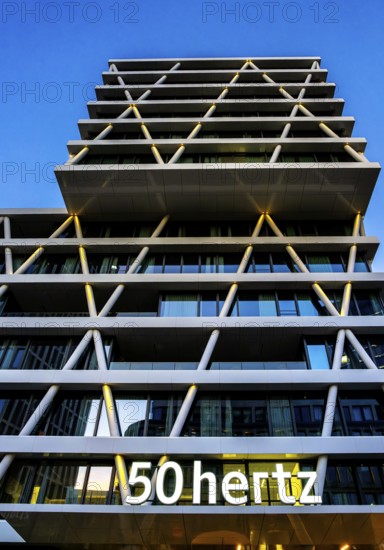 The picture shows the modern 50 hertz office and commercial building at the central station, warm evening light, frog perspective, Berlin, Germany