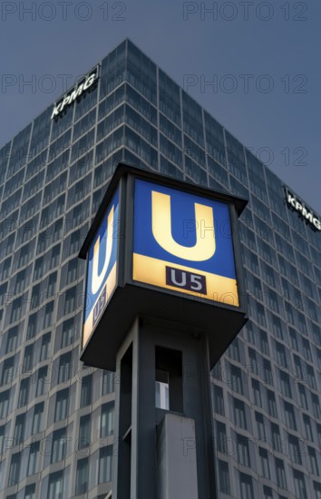 The picture shows a modern high-rise building in Berlin with the KPMG logo and a striking underground station sign for the U5 line, Berlin, Germany