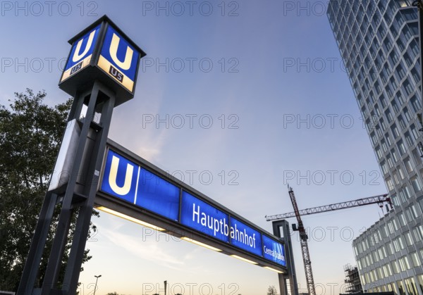 The picture shows a modern high-rise building in Berlin and a striking underground station sign from the main railway station and the U5 line, Berlin, Germany
