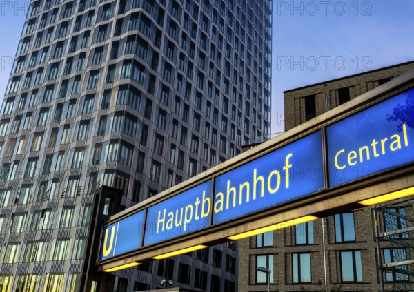 The picture shows a modern high-rise building in Berlin and a striking underground station sign from the main railway station and the U5 line, Berlin, Germany