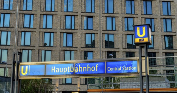 The picture shows a modern high-rise building in Berlin and a striking underground station sign from the main railway station and the U5 line, Berlin, Germany