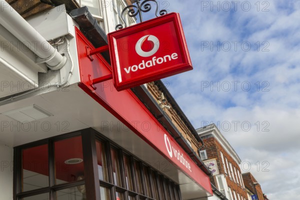 Vodafone sign with logo on shopfront of Vodafone phone shop, Marlborough, Wiltshire, England, UK