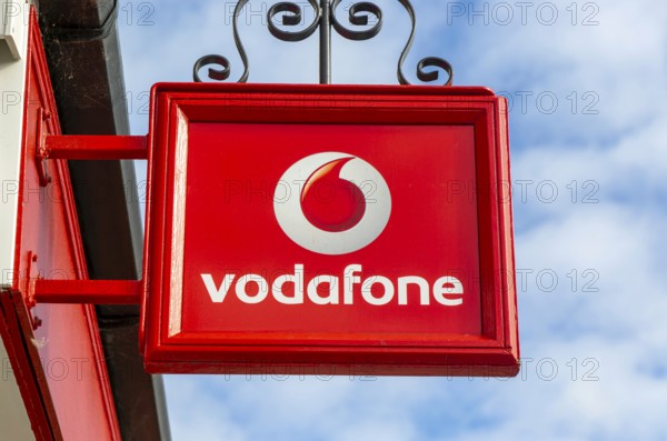 Vodafone sign with logo on shopfront of Vodafone phone shop, Marlborough, Wiltshire, England, UK
