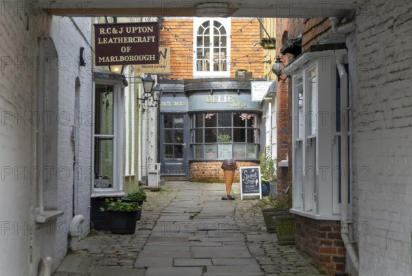 Specialist shops in historic alleyway of Old Hughenden Yard off the High Street in Marlborough, Wiltshire, England, UK