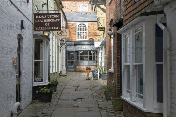 Specialist shops in historic alleyway of Old Hughenden Yard off the High Street in Marlborough, Wiltshire, England, UK