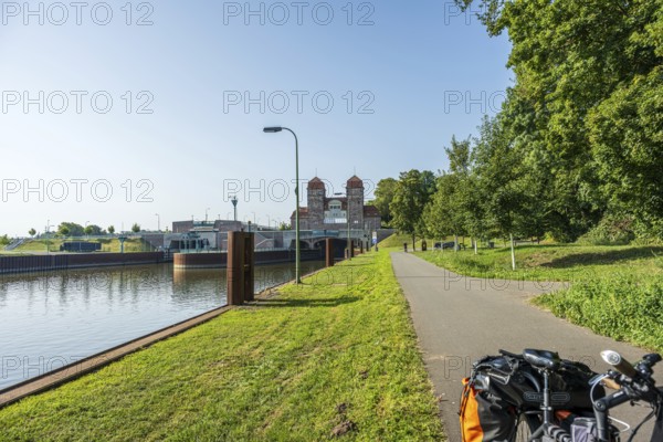 Bicycle standing on a canal path next to a lock, surrounded by green nature, Minden waterway junction, Minden-Lübbecke, North Rhine-Westphalia