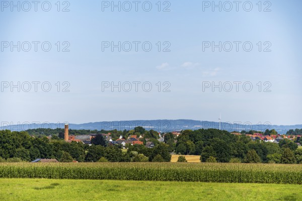 A rural view of a village surrounded by fields and trees under a blue sky, Bielefeld, Westphalia, North Rhine-Westphalia