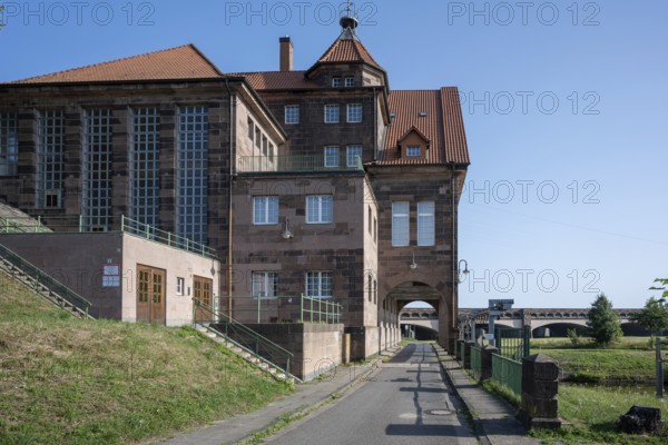 Historic building with red brick roof and large entrance gate under a blue sky, Minden waterway junction, Minden-Lübbecke, North Rhine-Westphalia