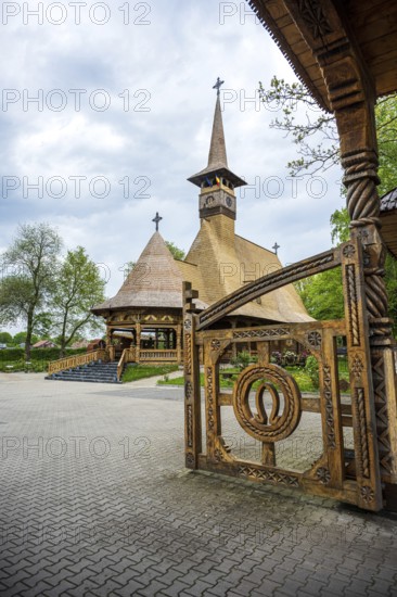 Artfully carved wooden church with horseshoes on the Tor tor in front of a cloudy sky, The Romanian Orthodox church near Sögel in Emsland