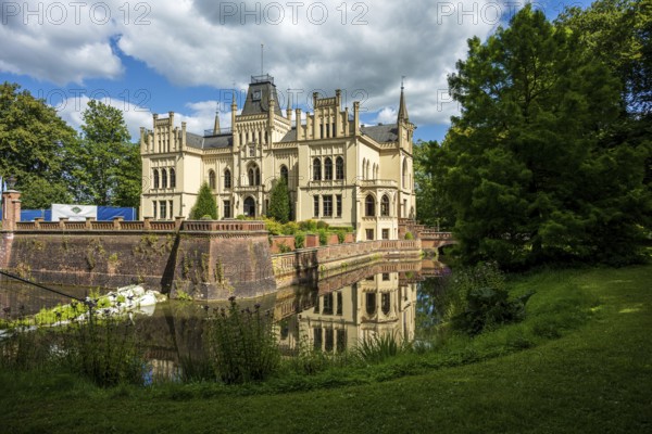Gothic castle in perspective with moat surrounded by green landscape, Evenburg Castle, Leer, East Frisia