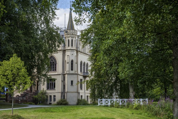 A castle with Gothic elements, surrounded by green landscape and trees, Schloss Evenburg, Leer, East Frisia