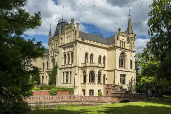 A Gothic castle with architectural details and surrounded by trees, Schloss Evenburg, Leer, East Frisia