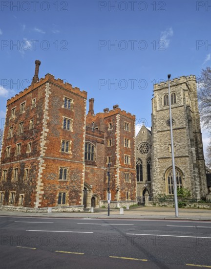 Morton's Tower, the gatehouse to Lambeth Palace, residence of Archbishop of Canterbury in London, United Kingdom. Historical street view to the classic red brick palace under a bright blue sky