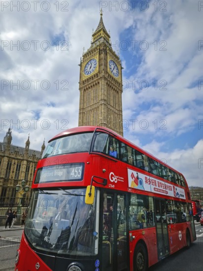 LONDON, UNITED KINGDOM - APRIL 15, 2023 A classic London scene with a red double-decker bus in the foreground and the iconic Elizabeth Tower, home of Big Ben, rising majestically behind