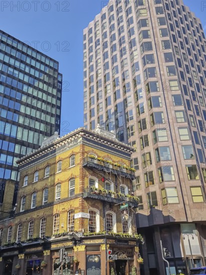 LONDON, UNITED KINGDOM - APRIL 15, 2023 Street view of The Albert pub in London, a striking vintage Victorian style building contrasting with the modern high-rise constructions
