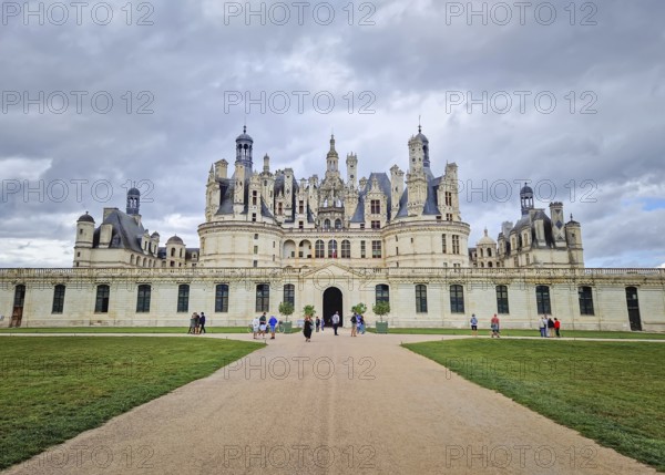 Chambord, Loir-et-Cher, France - August 30, 2023 Chateau de Chambord, a majestic medieval castle with green gardens. Iconic French Renaissance architecture palace, under a dramatic, cloudy sky