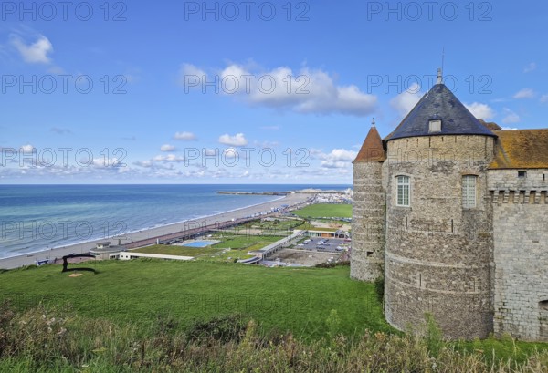 Chateau de Dieppe, a historic fortress perched on a cliff overlooking the turquoise waters of the English Channel. The stone castle with pointed towers has view to the town and a long pebble beach