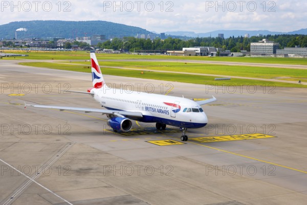 British Airways Passenger Airplane Taxiing on Runway in a Sunny Summer Day From the Airport in Kloten, Zurich, Zurich Canton, Switzerland