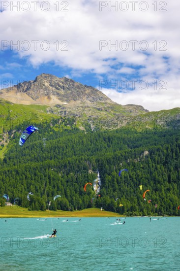 Kitesurfing on Alpine Lake Silvaplana in a Sunny Summer Day with Mountain View in the Swiss Alps in Silvaplana, Maloja, Grisons, Switzerland
