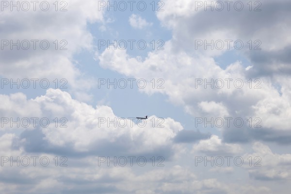 Passenger Airplane Flying Against Blue Sky and Clouds in a Sunny Summer Day From the Airport in Kloten, Zurich, Zurich Canton, Switzerland