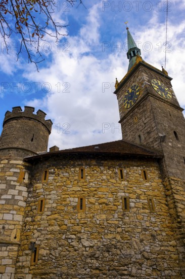 Clock Tower and Fortification Tower and Wall with Blue Sky and Clouds in a Sunny Autumn Day in City of Biel, Bienne, Bern Canton, Switzerland