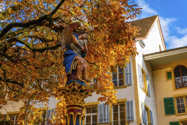 Beautiful Old Town with a Tree and Statue in a Sunny Day in Autumn in Biel, Bienne, Bern Canton, Switzerland