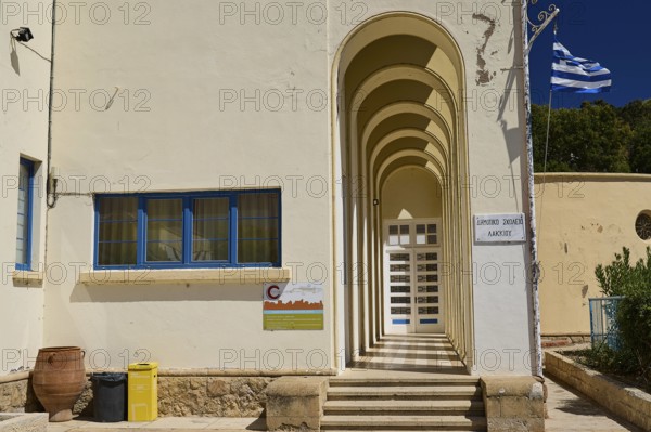 Primary school, entrance area with arches and Greek flag on the wall, Historicism, Art Deco, Rationalism, Portolago, Lakki, Leros, Dodecanese, Greek Islands, Greece