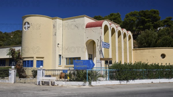 Primary school, Modern yellow building with arched entrances and Greek flag, Historicism, Art Deco, Rationalism, Portolago, Lakki, Leros, Dodecanese, Greek Islands, Greece
