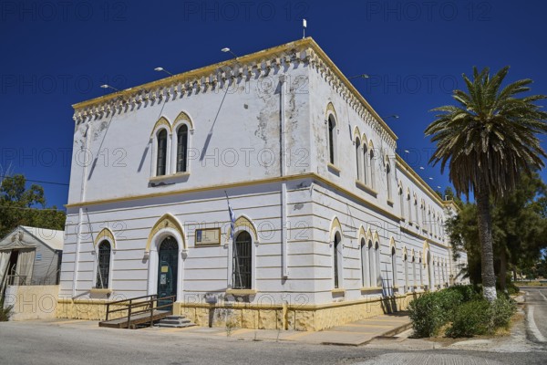 Marine Administration, Caserma Marina 1930, Today Municipal Administration, White classical building with palm trees and blue windows under a clear sky, Historicism, Art Deco, Rationalism, Portolago, Lakki, Leros, Dodecanese, Greek Islands, Greece