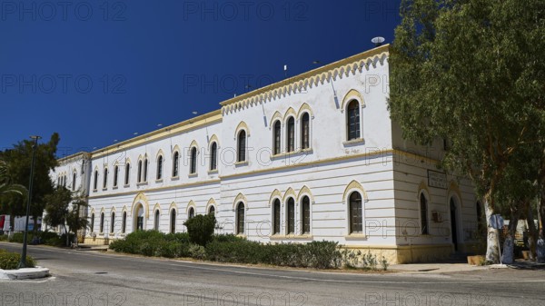Marine Administration, Caserma Marina 1930, Today Municipal Administration, White historic building with arched windows and green surroundings, Historicism, Art Deco, Rationalism, Portolago, Lakki, Leros, Dodecanese, Greek Islands, Greece