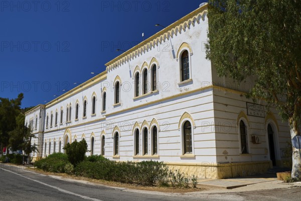 Marine Administration, Caserma Marina 1930, Today Municipal Administration, Large white building with arches and many windows under a clear sky, Historicism, Art Deco, Rationalism, Portolago, Lakki, Leros, Dodecanese, Greek Islands, Greece